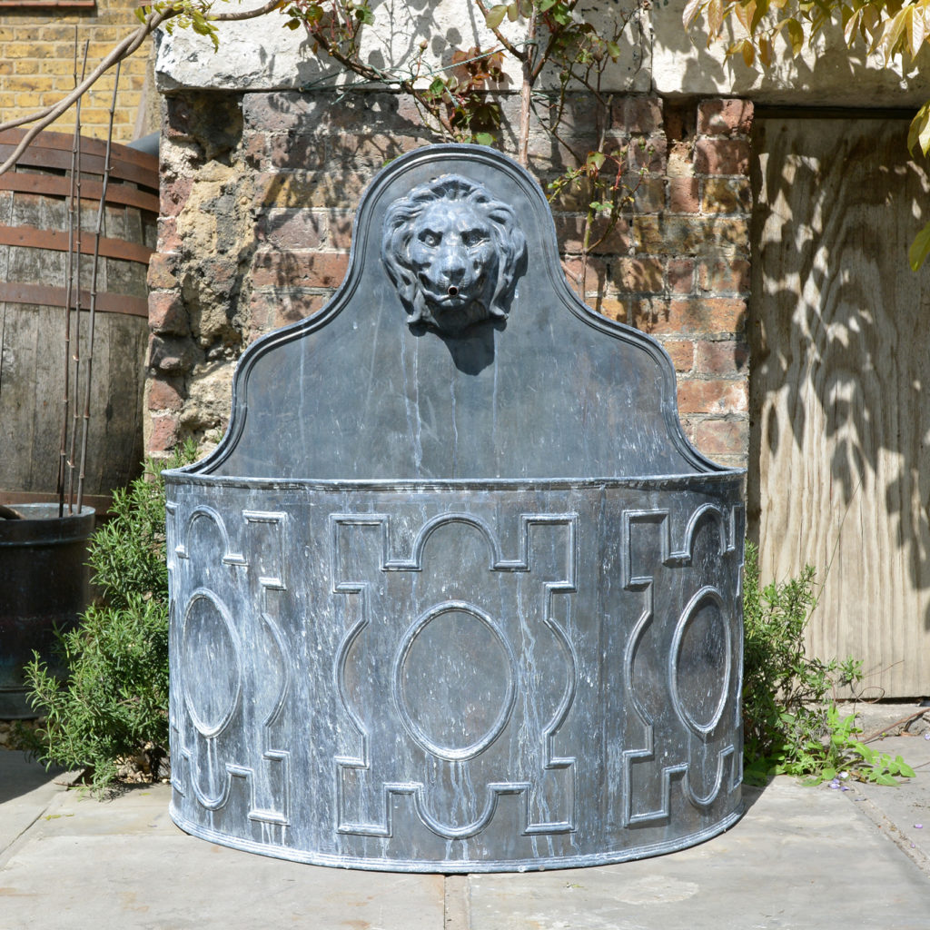 An English lead cistern with lion spout