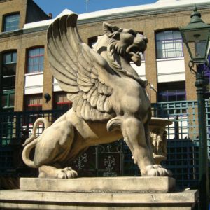 A massive French reconstituted stone winged lion-0