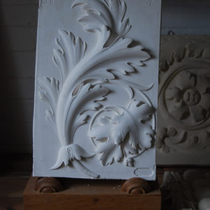 A cast plaster relief depicting a spray of acanthus leaves-0