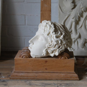 A cast plaster fragment of a classical head-0