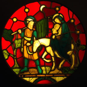 A stained and painted glass window panel depicting the flight to Egypt-0