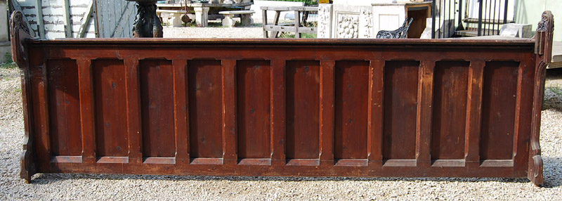 A Victorian pine pew front with carved termini-0