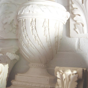 An English relief cast plaster lidded half-urn-0