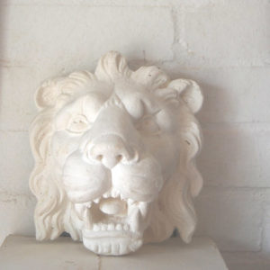 An English relief cast plaster head of a lion-0