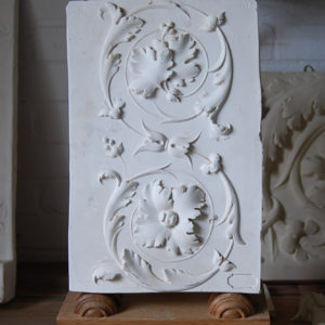 A cast plaster section of open scroll frieze-0