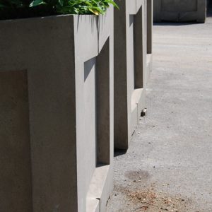 A series of massive, concrete, Brutalist treeplanters-0