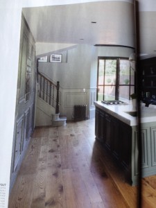 The aged oak flooring works perfectly in the large open plan kitchen and offsets the painted cabinetry as well as the salvaged radiator at the foot of the stairs.