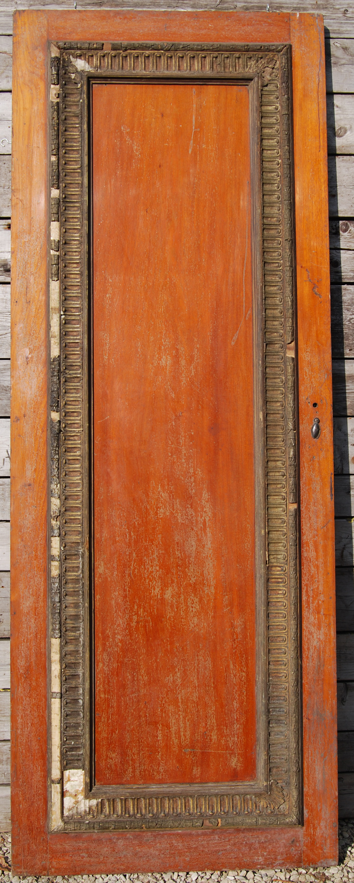 A large single panel mahogany door