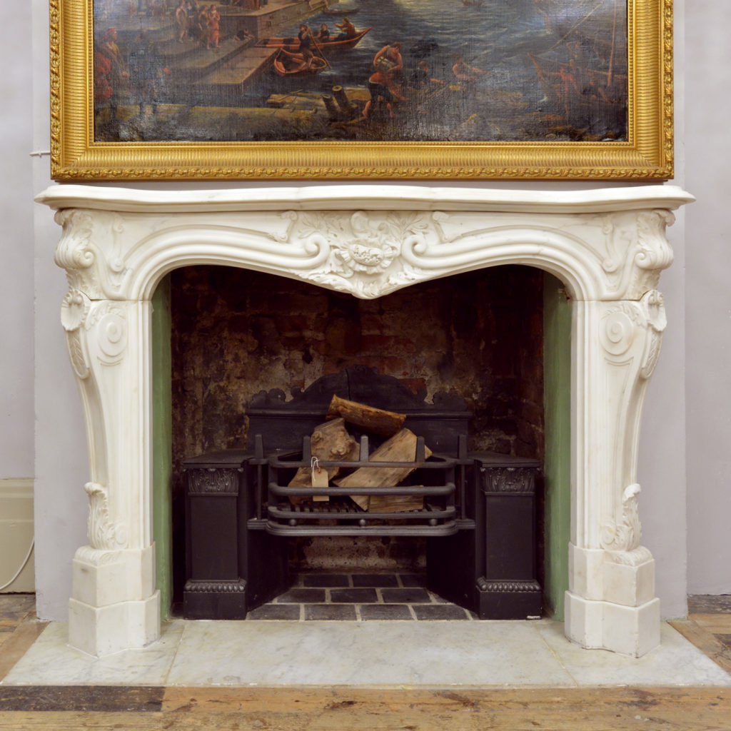 A Rococo Revival white Carrara marble chimneypiece