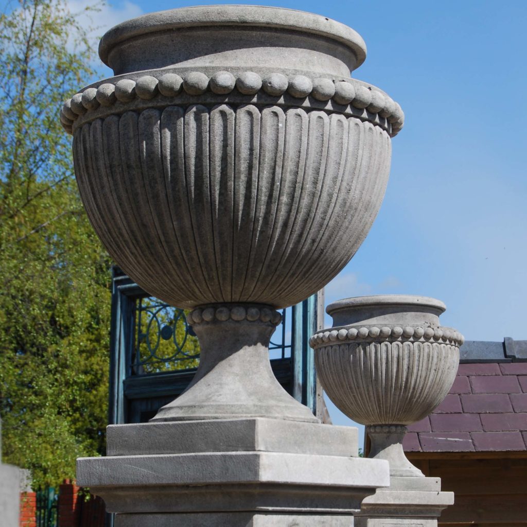 A carved limestone urn on pedestal-0