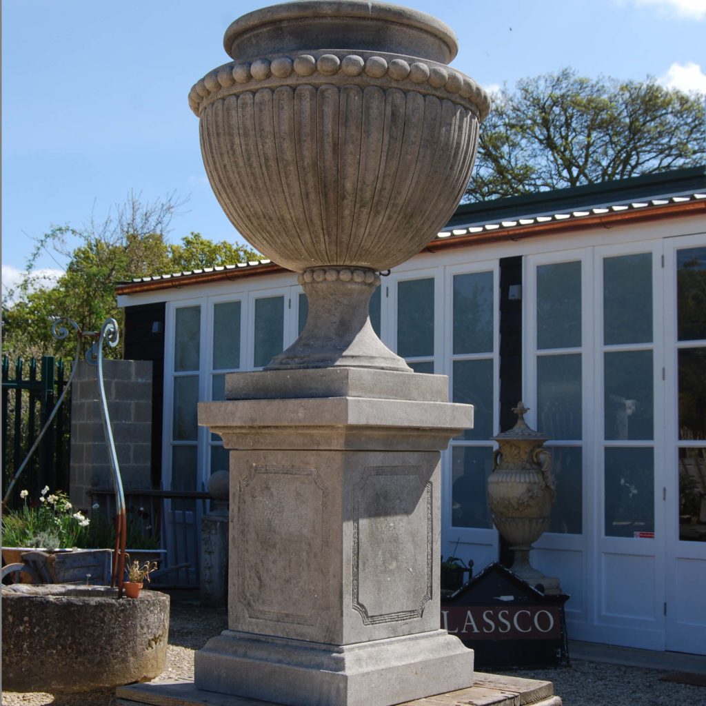 A carved limestone urn on pedestal-104266