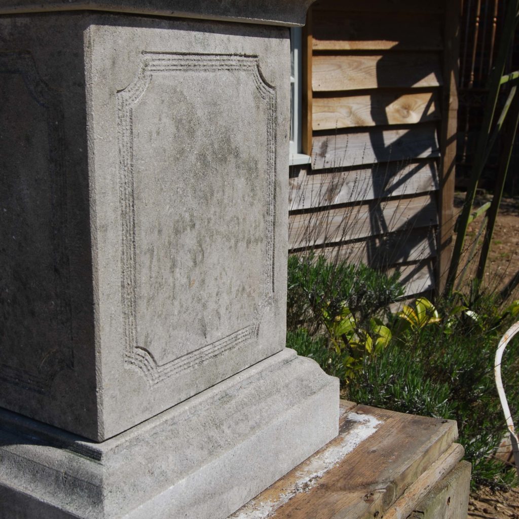 A carved limestone urn on pedestal-104268