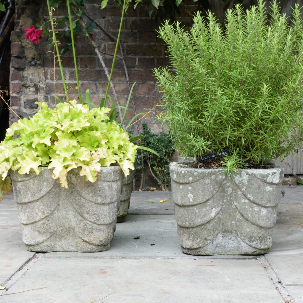 Four quatrefoil composition stone planters,-0