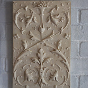 A relief-cast plaster plaque of opposed foliate scrolls,-0