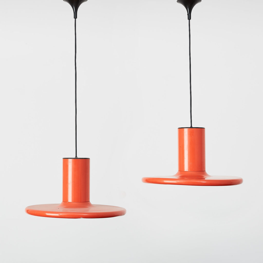 A pair of orange pendant lights by LITA,-0