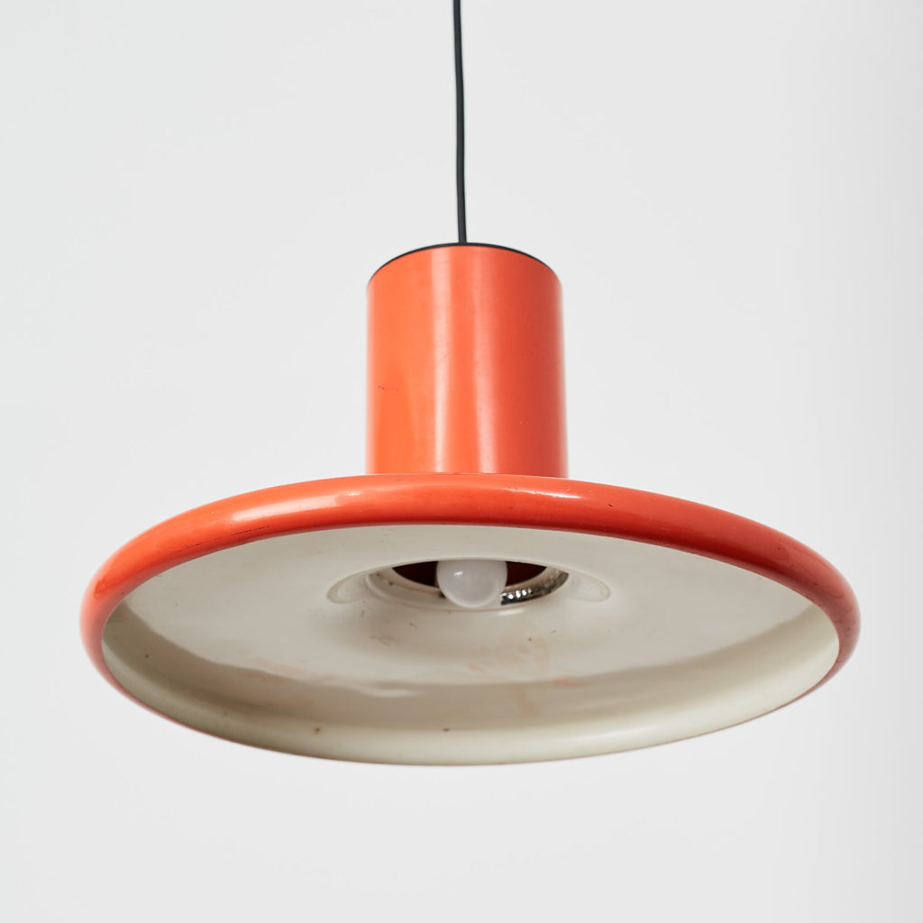 A pair of orange pendant lights by LITA,-121625