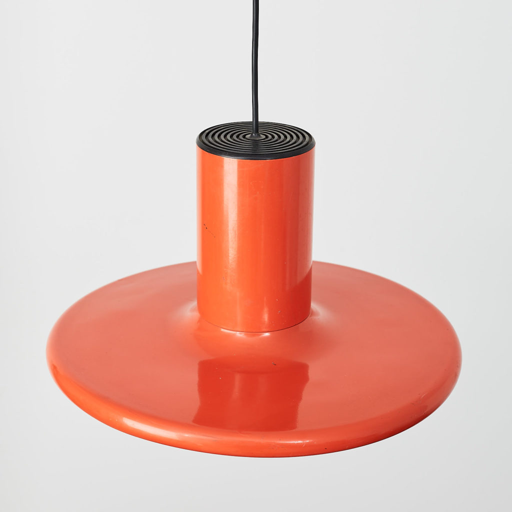 A pair of orange pendant lights by LITA,-121631