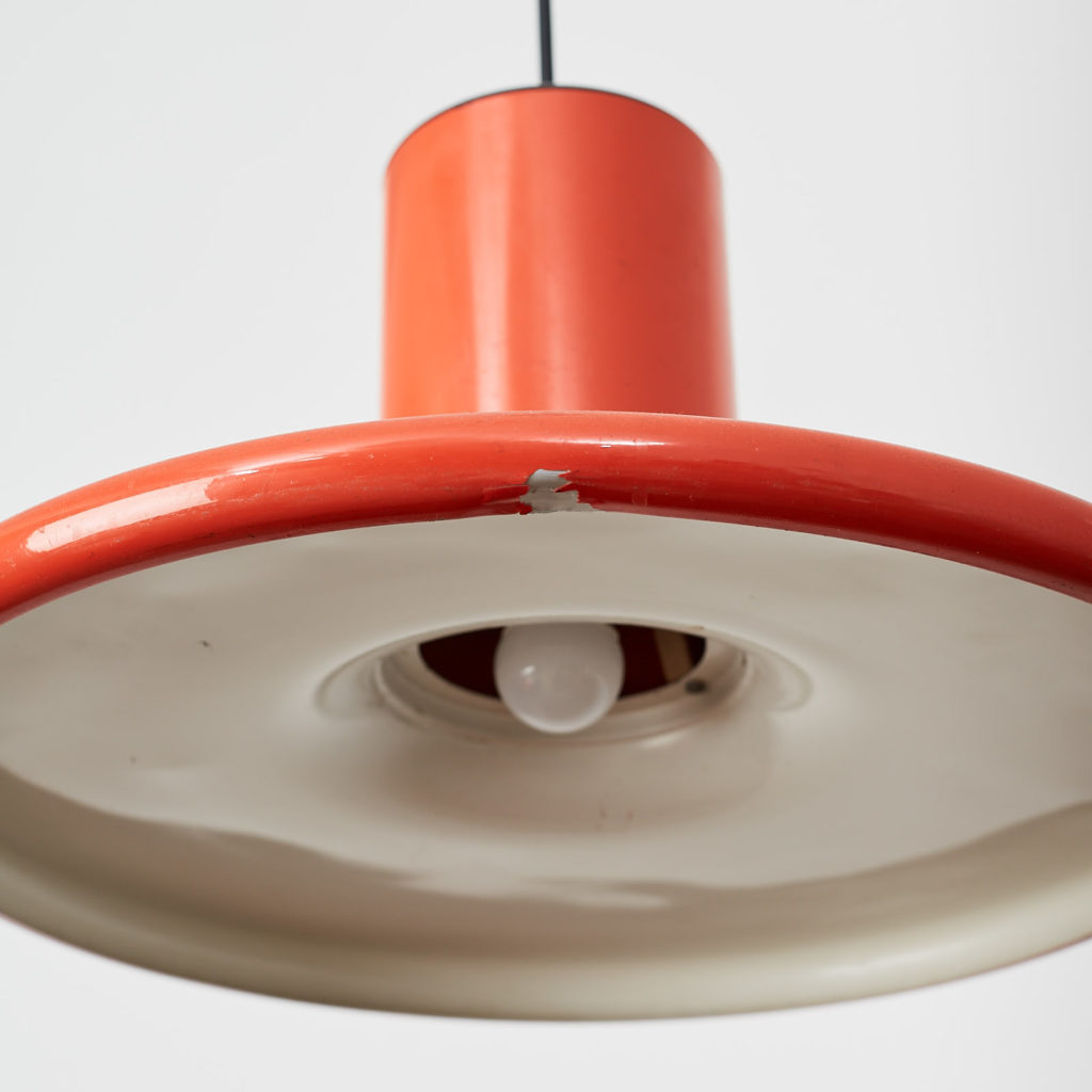 A pair of orange pendant lights by LITA,-121626