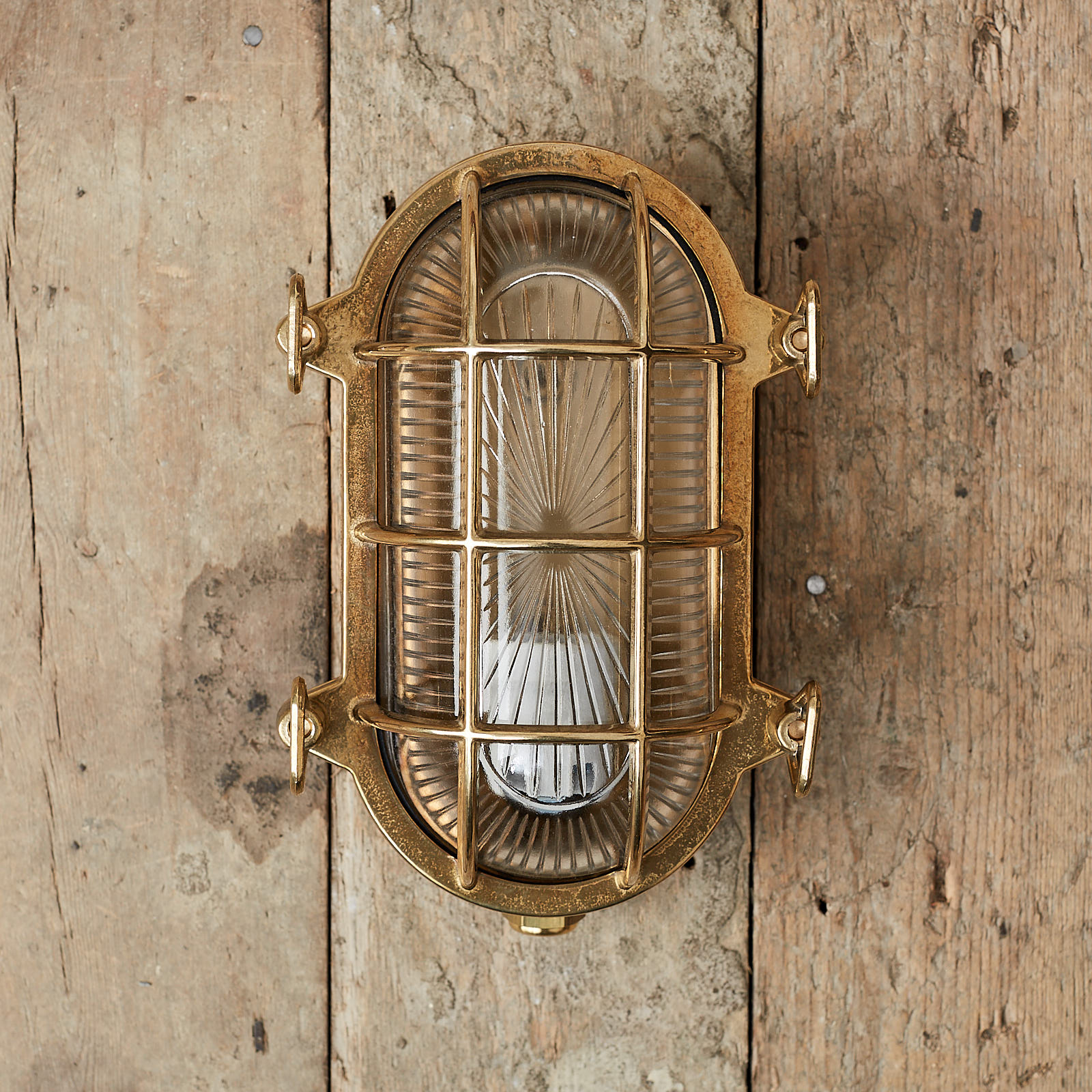A polished brass bulkhead light, - LASSCO - England's prime