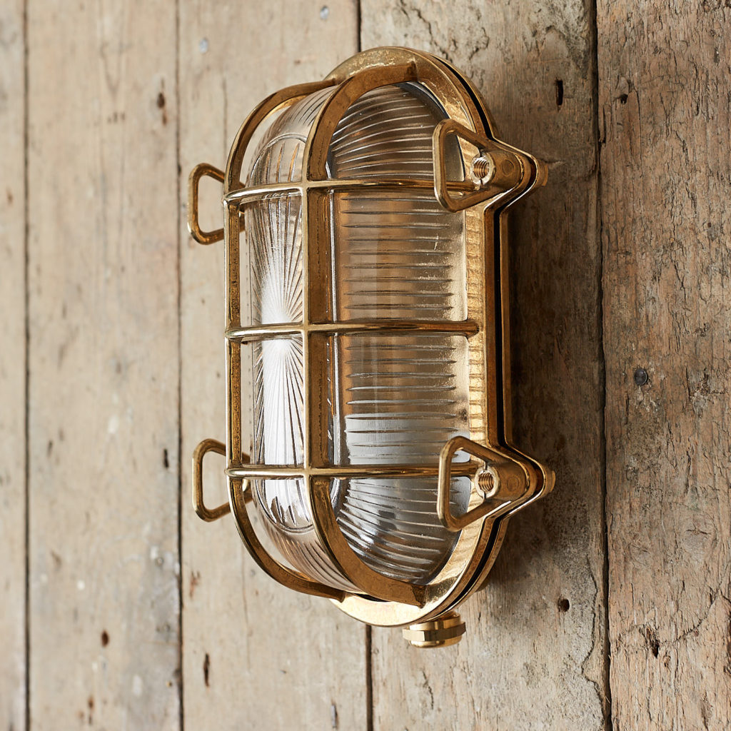 A polished brass bulkhead light,-121543