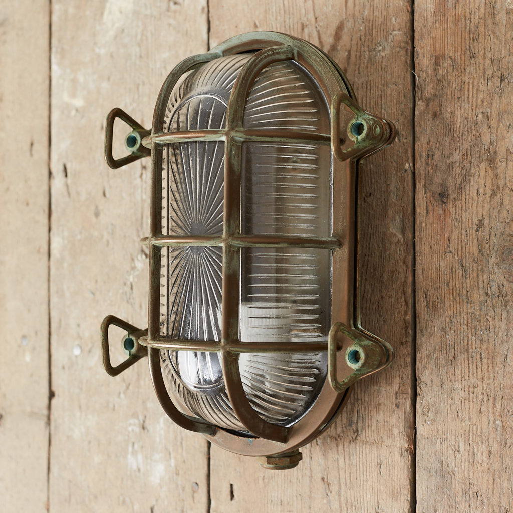 An aged brass bulkhead light,-121554