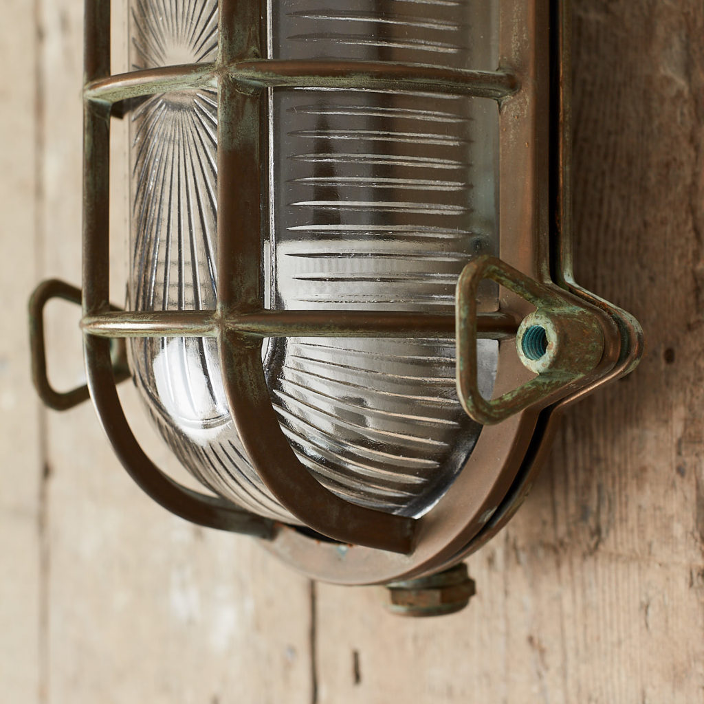 An aged brass bulkhead light,-121555