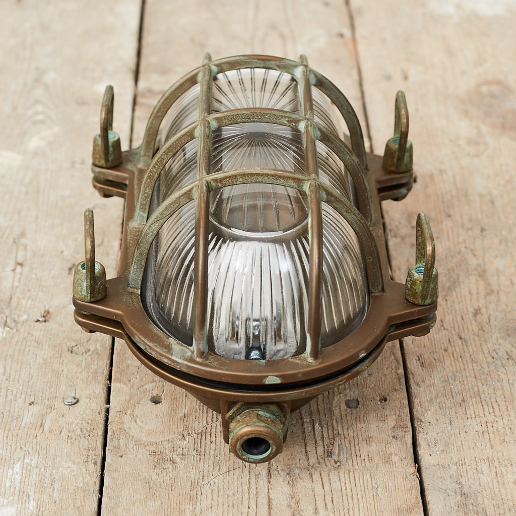 An aged brass bulkhead light,-121552