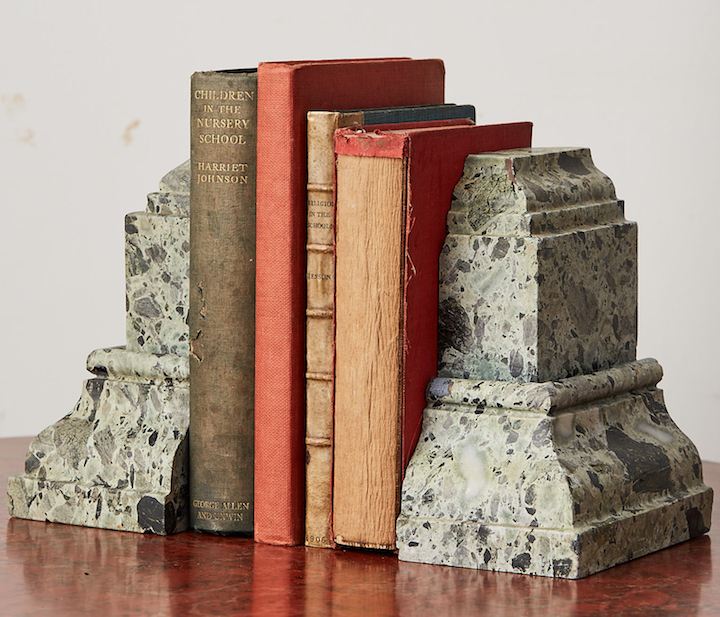 Green marble bookends containing books