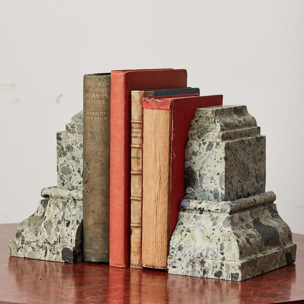 Green verde antico marble bookends with books