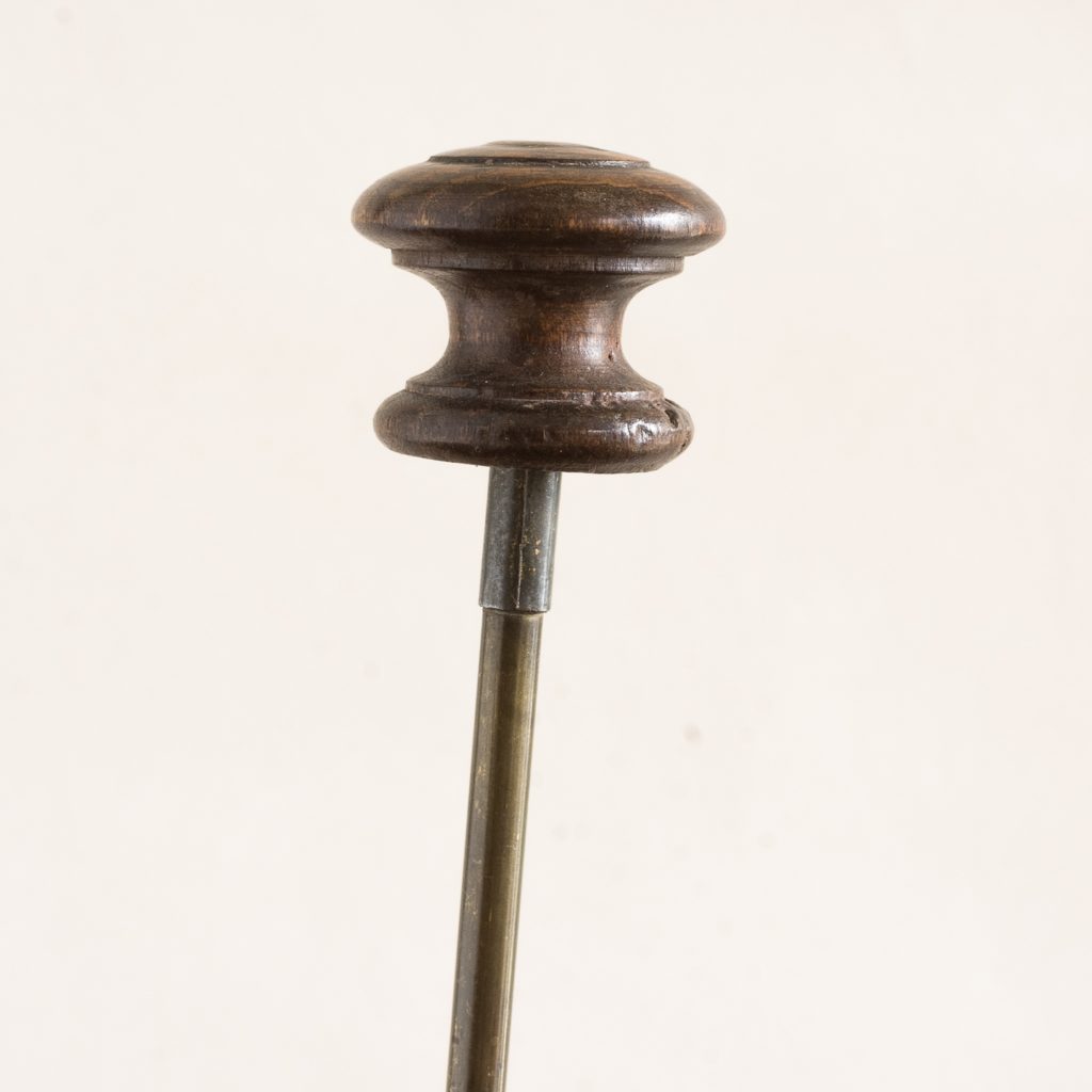 turned timber knob on brass upright