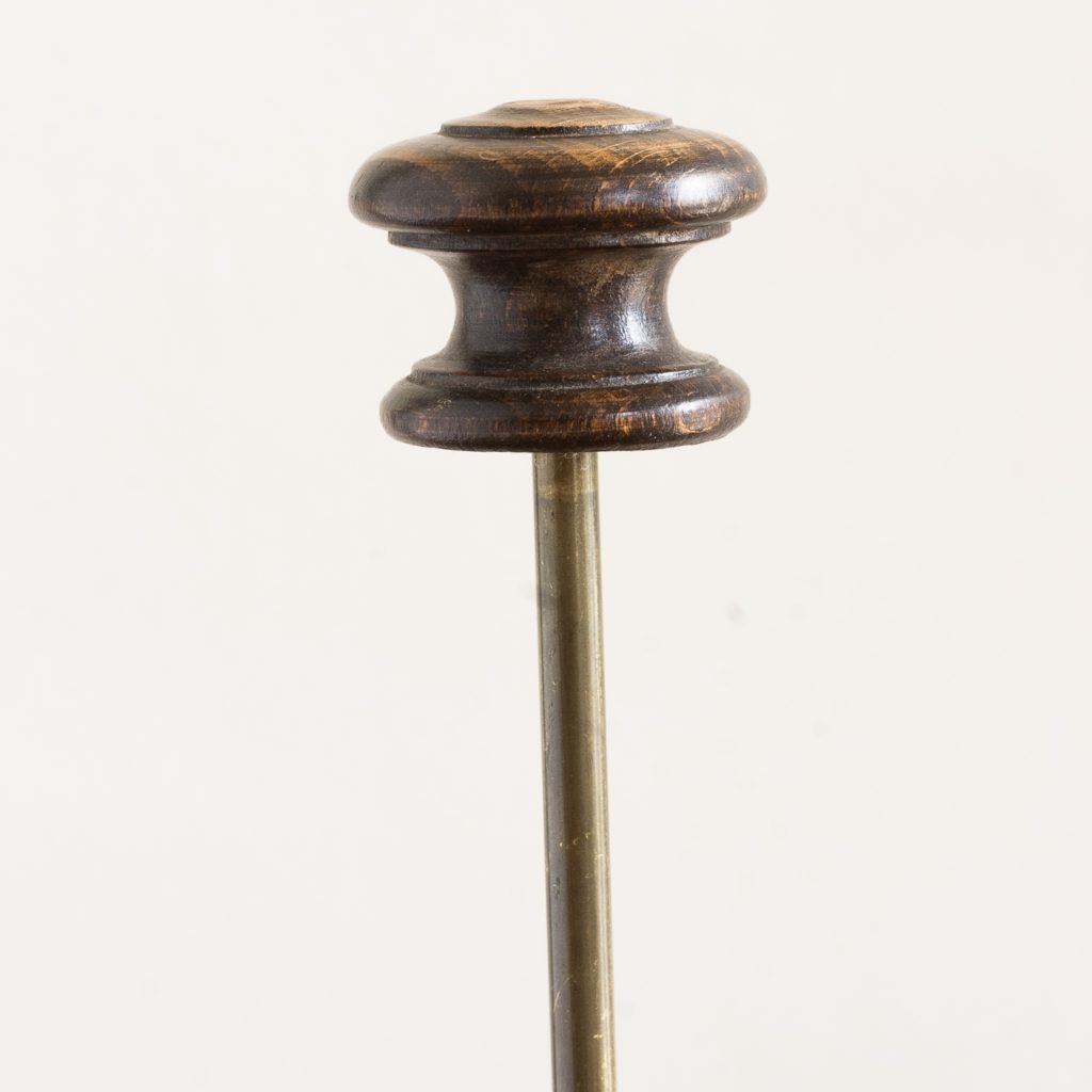 turned timber knob on brass upright