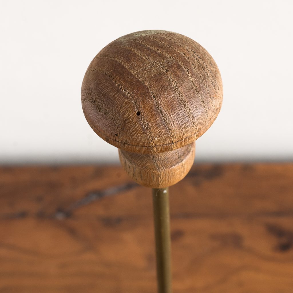 turned timber knob on brass upright