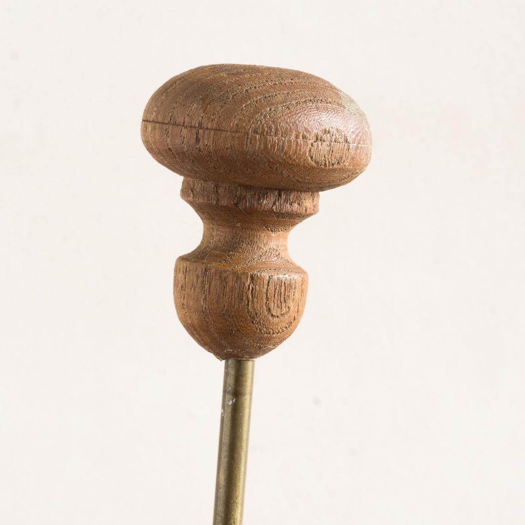 turned timber knob on brass upright