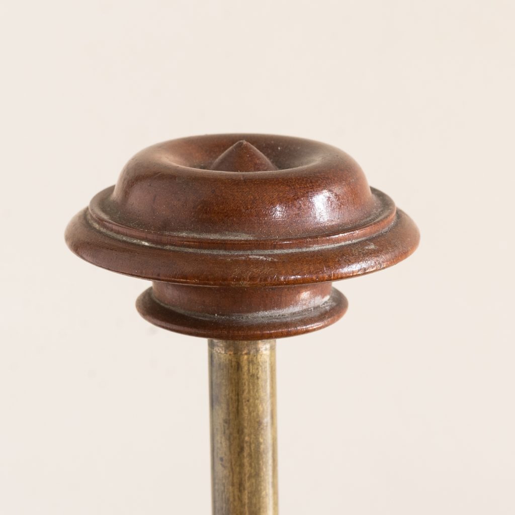 turned timber knob on brass upright