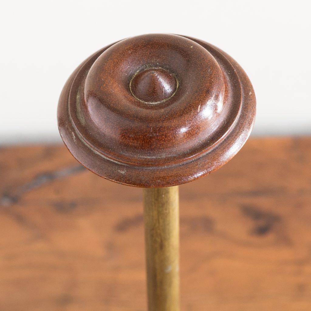 turned timber knob on brass upright