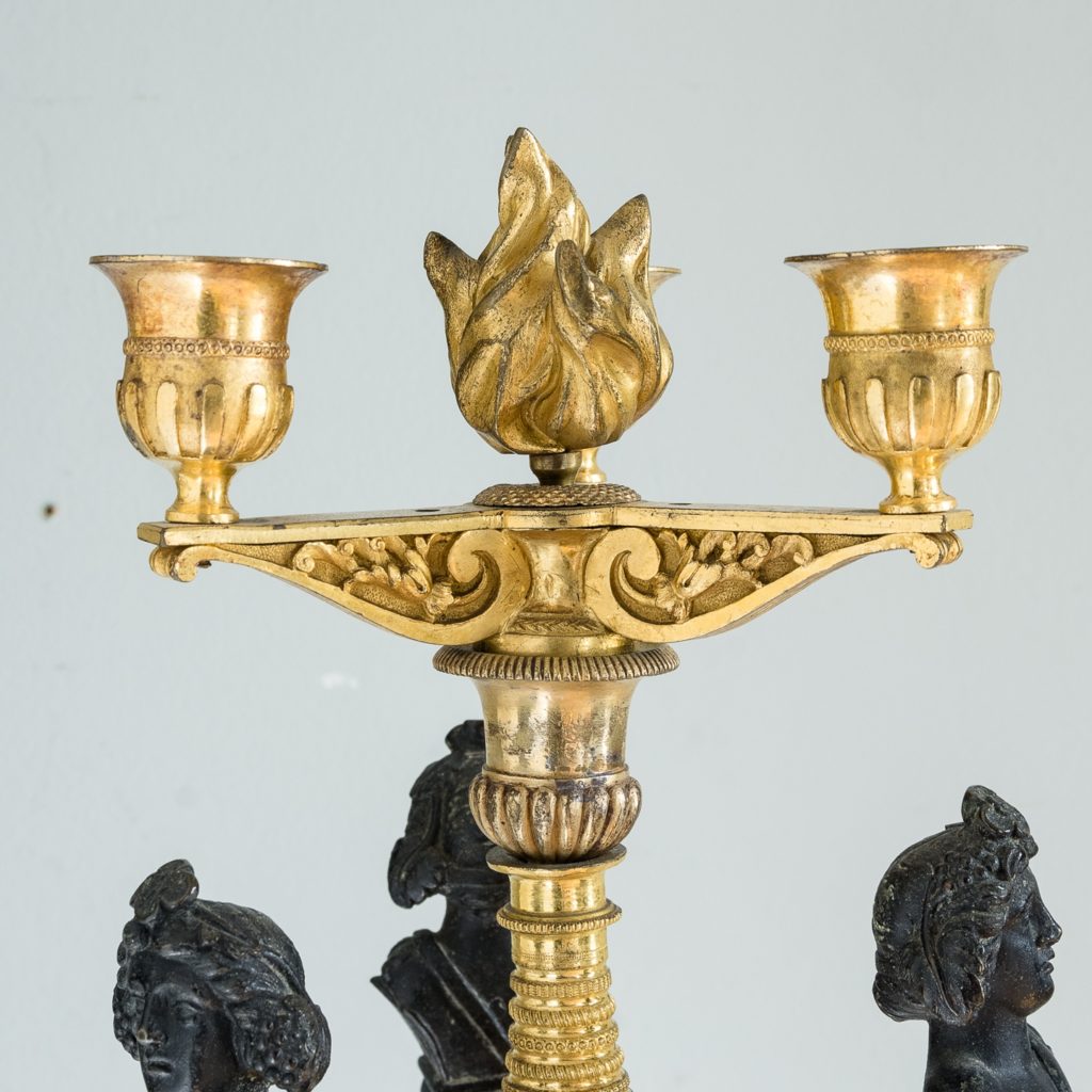 nozzles supported by architectural brackets with flaming urn to the centre