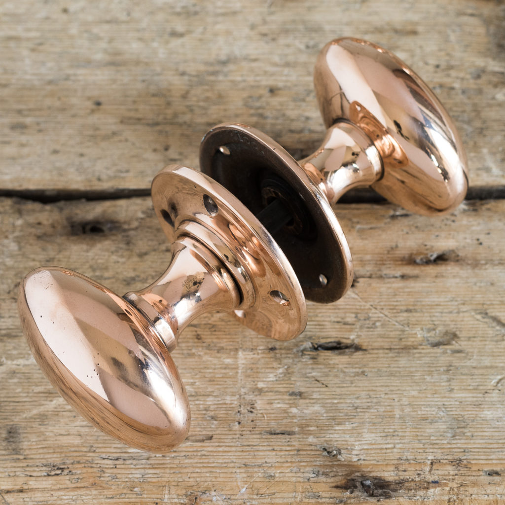 Large early twentieth century oval rose brass door knobs,