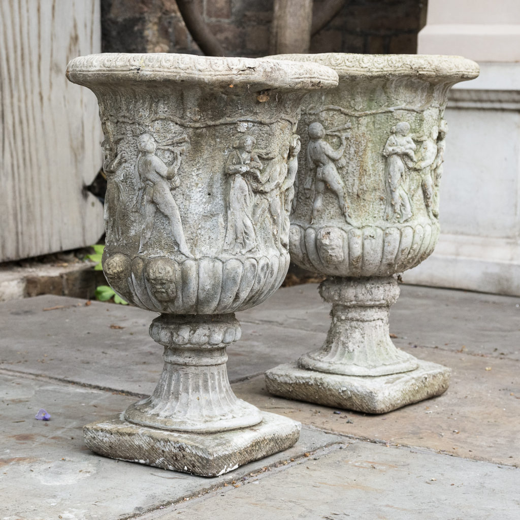 Pair of reconstituted stone Medici urns,