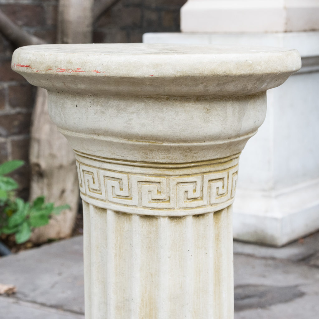 Fluted cast stone pedestal,