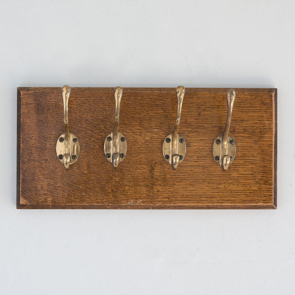 Set of 4 mounted brass coat hooks