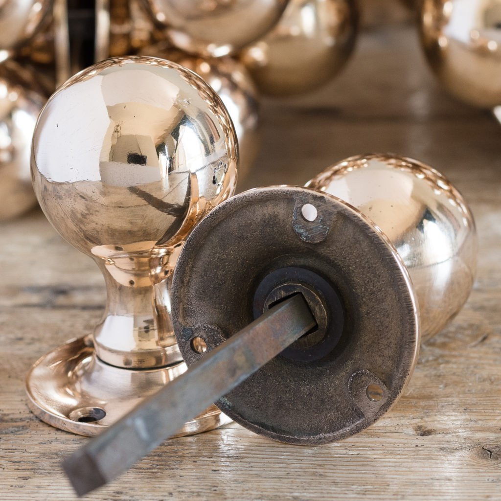 Long run of large antique bronze spherical door knobs,-127779