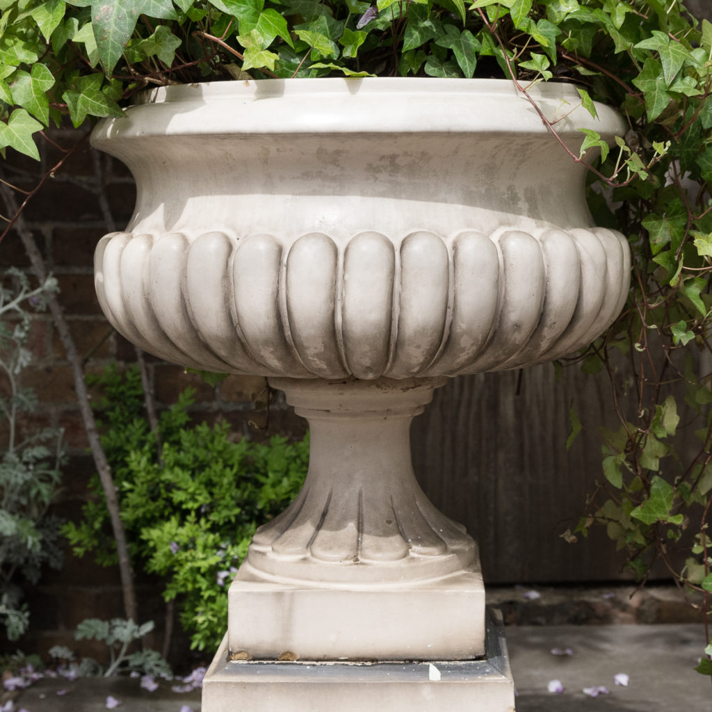 Pair of Victorian glazed terracotta tazza urns with pedestals,