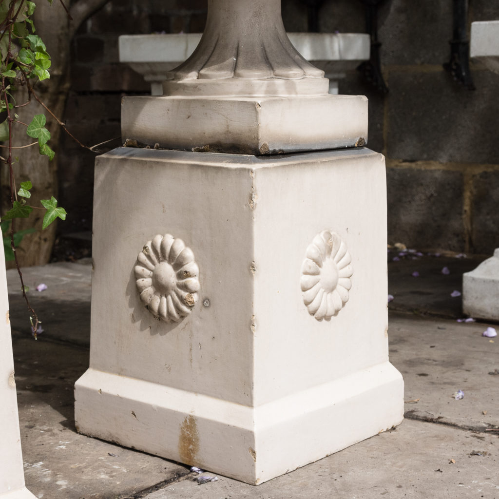 tapered pedestals with foliate motif to each side