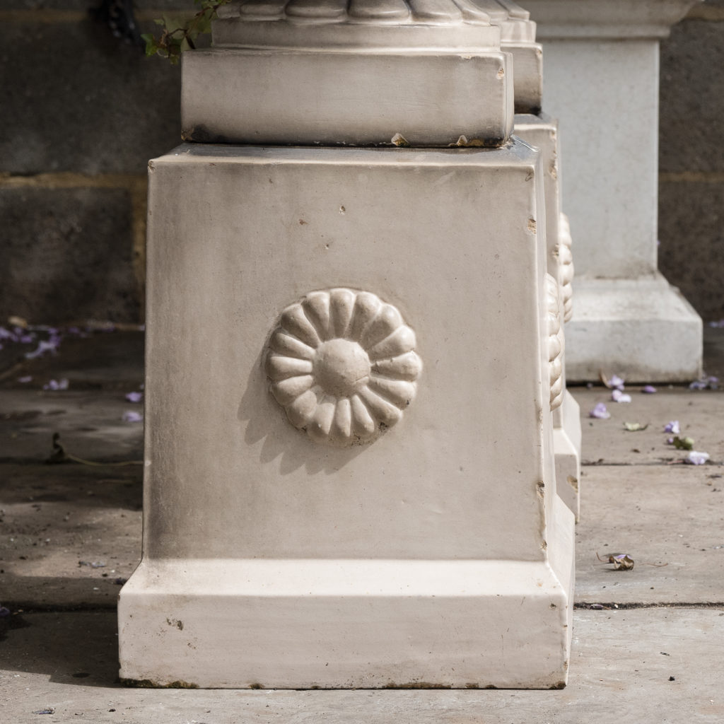 tapered pedestals with foliate motif to each side