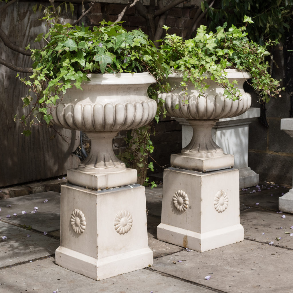 Pair of Victorian glazed terracotta tazza urns with pedestals,