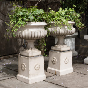 Pair of Victorian glazed terracotta tazza urns with pedestals,