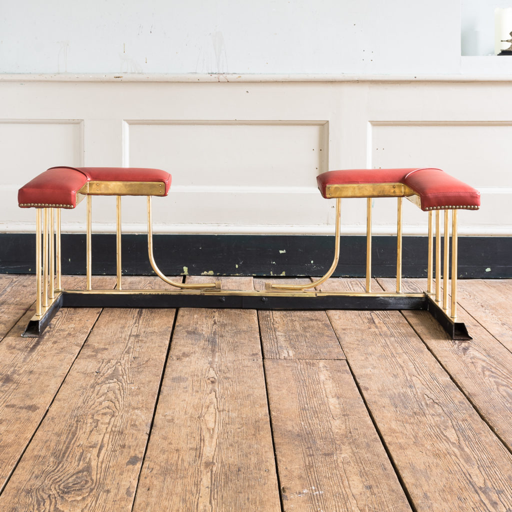 Twentieth century brass and leather upholstered club fender,