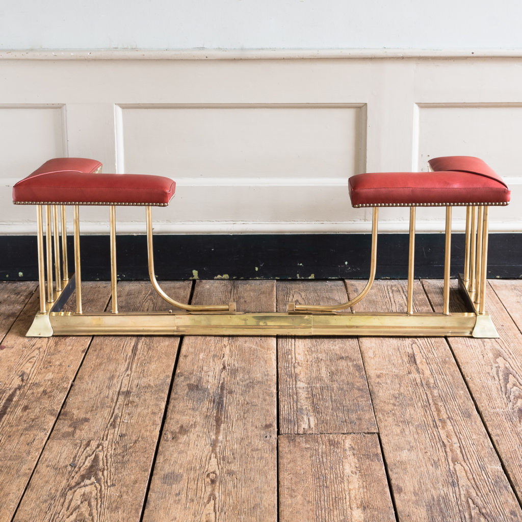 Twentieth century brass and leather upholstered club fender,