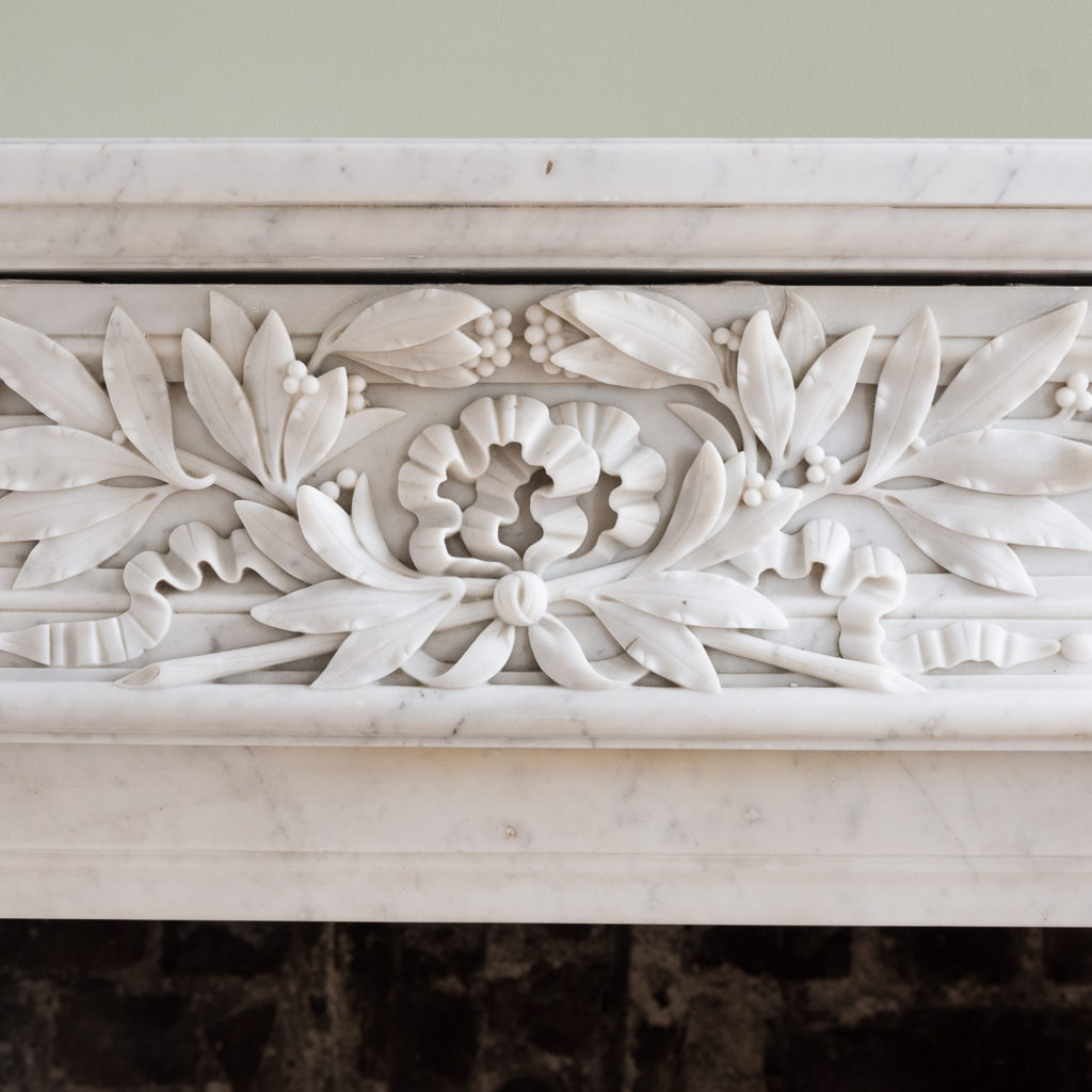 finely carved frieze of laurel leaves and bowed ribbon