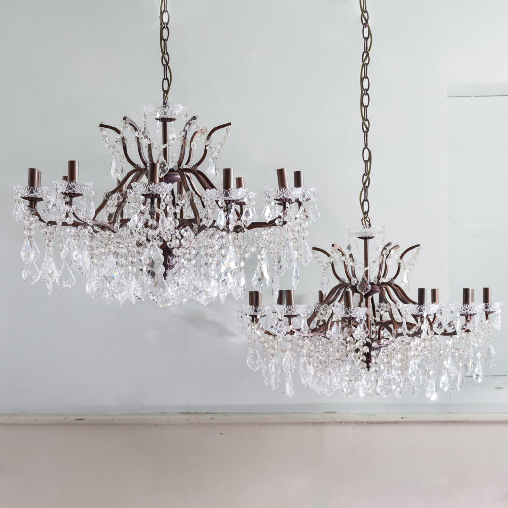 Twelve light glass lustre and bronzed metal chandeliers,